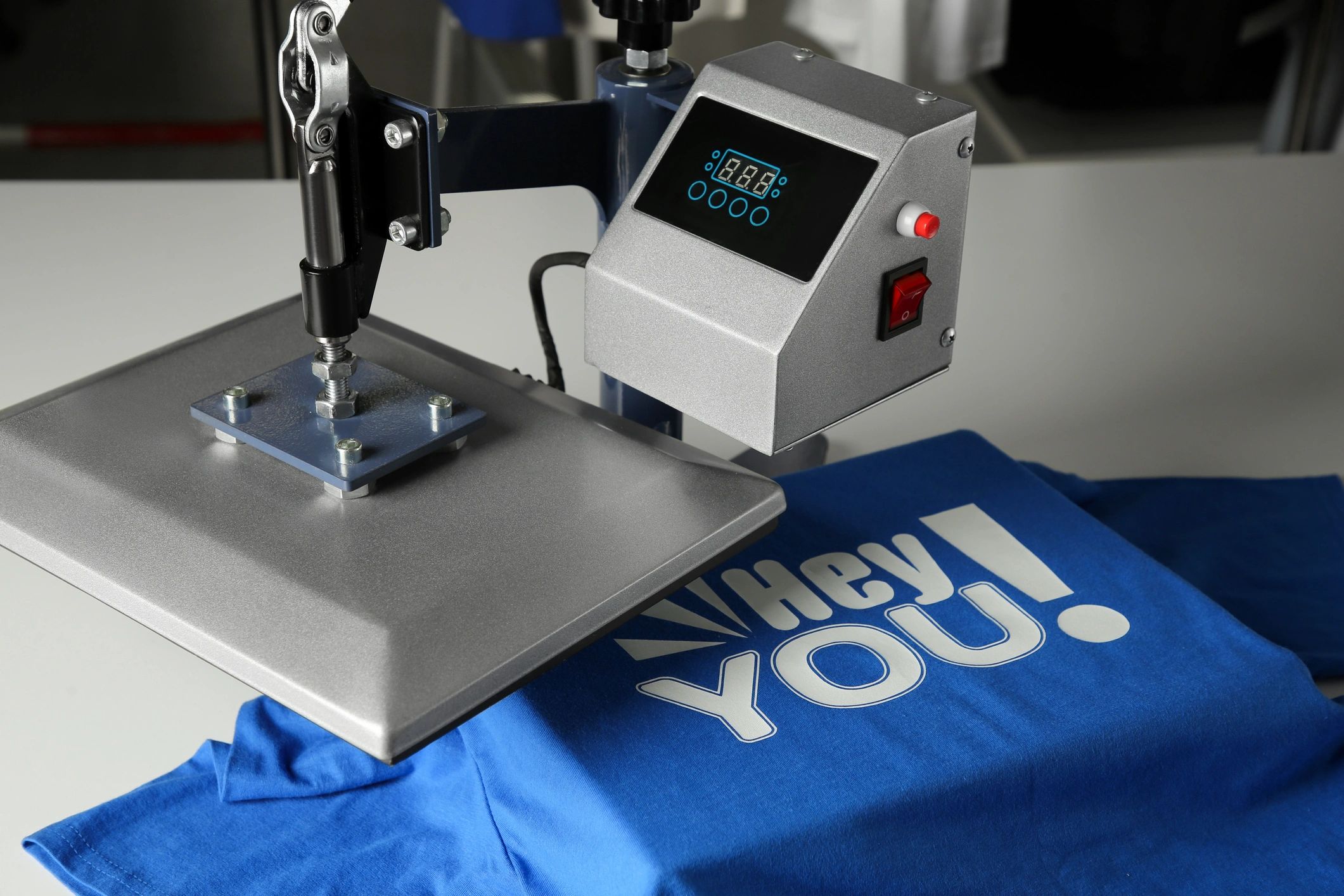 Heat press printing a t-shirt in a workshop